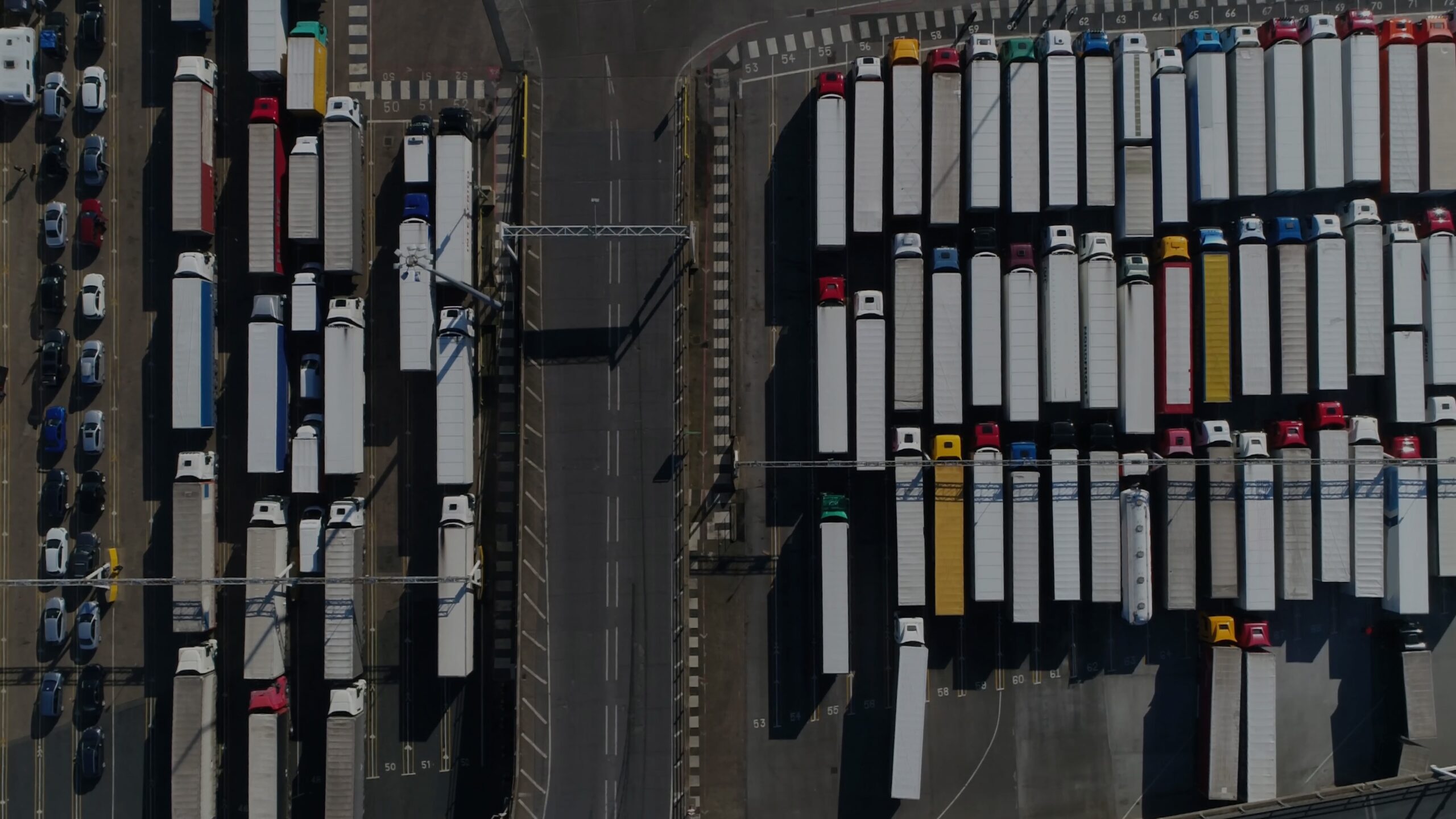 Aerial,Top,Down,Photo,Of,Harbor,And,Trucks,Parked,Along